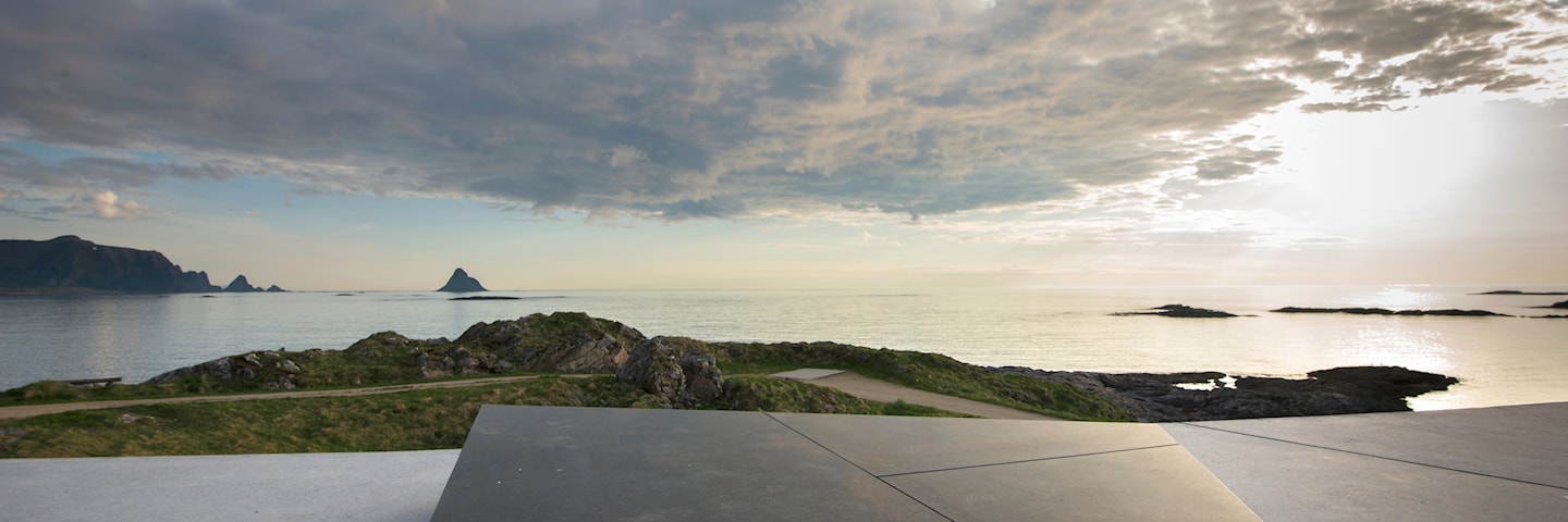 Kleivodden picnic area with a view of the sea, the sun breaking through the clouds.